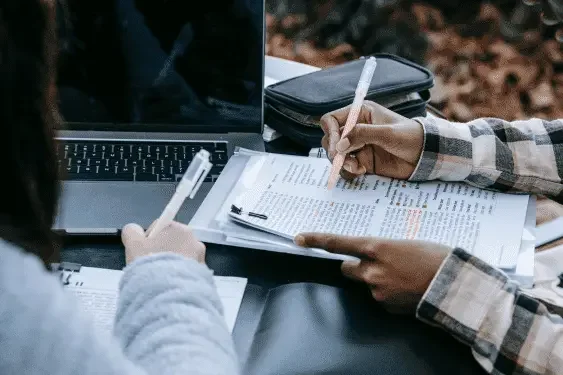 Image representing students working on computers and notepads