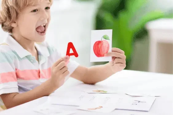 Image representing a child with flash cards and letters