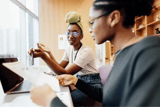 Image of two student working together and