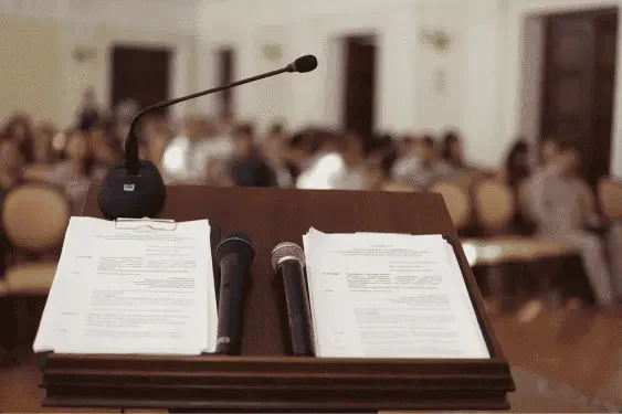 Image representing a lectern  notes and a microphone